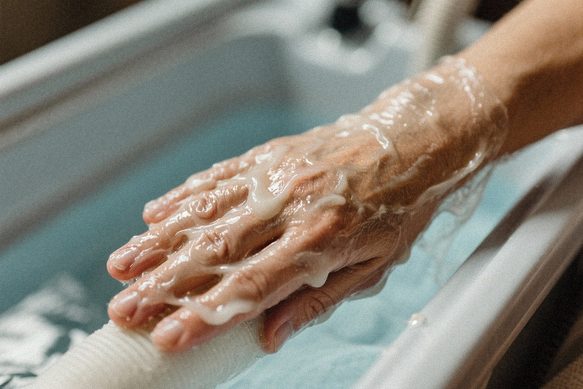 Mână acoperită cu parafină terapeutică